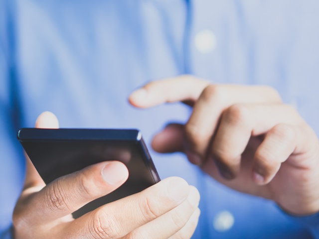 Man using mobile phone with copy space